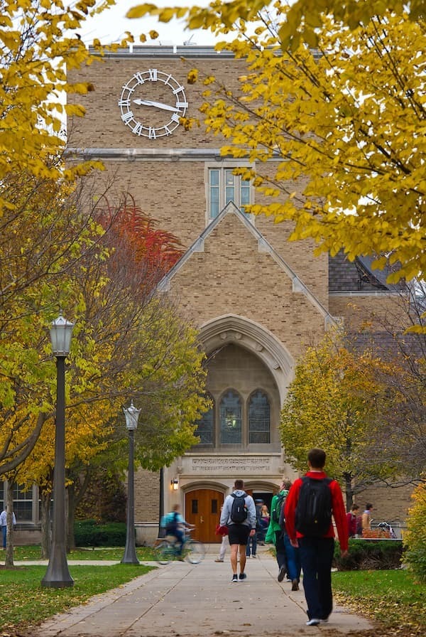 Students walking into O'Shaughnessy Hall in the fall.